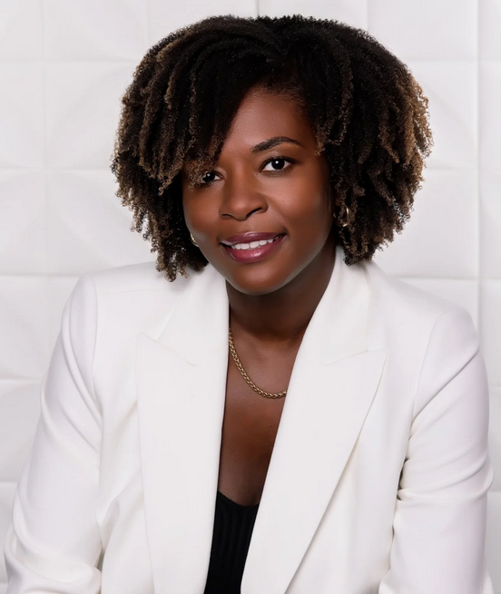 Head shot of Madjeen Lorthe smiling wearing a white blazer 